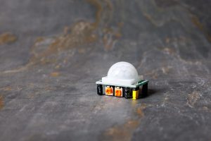 A closeup shot of an HC-SR501 PIR motion sensor module